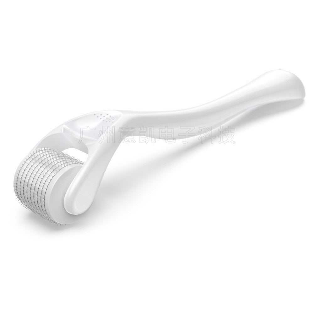 White facial roller on a white background